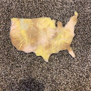 Wooden block of the us with Idaho glittered in